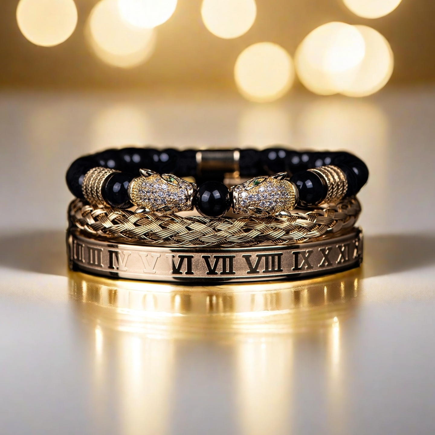 The Five Elements Series TAOÉ Gothic Black Panther Braid + Golden Steel Numeral Bracelet Panther Set-Metal features gold and black bands, including a braided bracelet, Roman numeral cuff, and beaded panther design against a radiant backdrop.