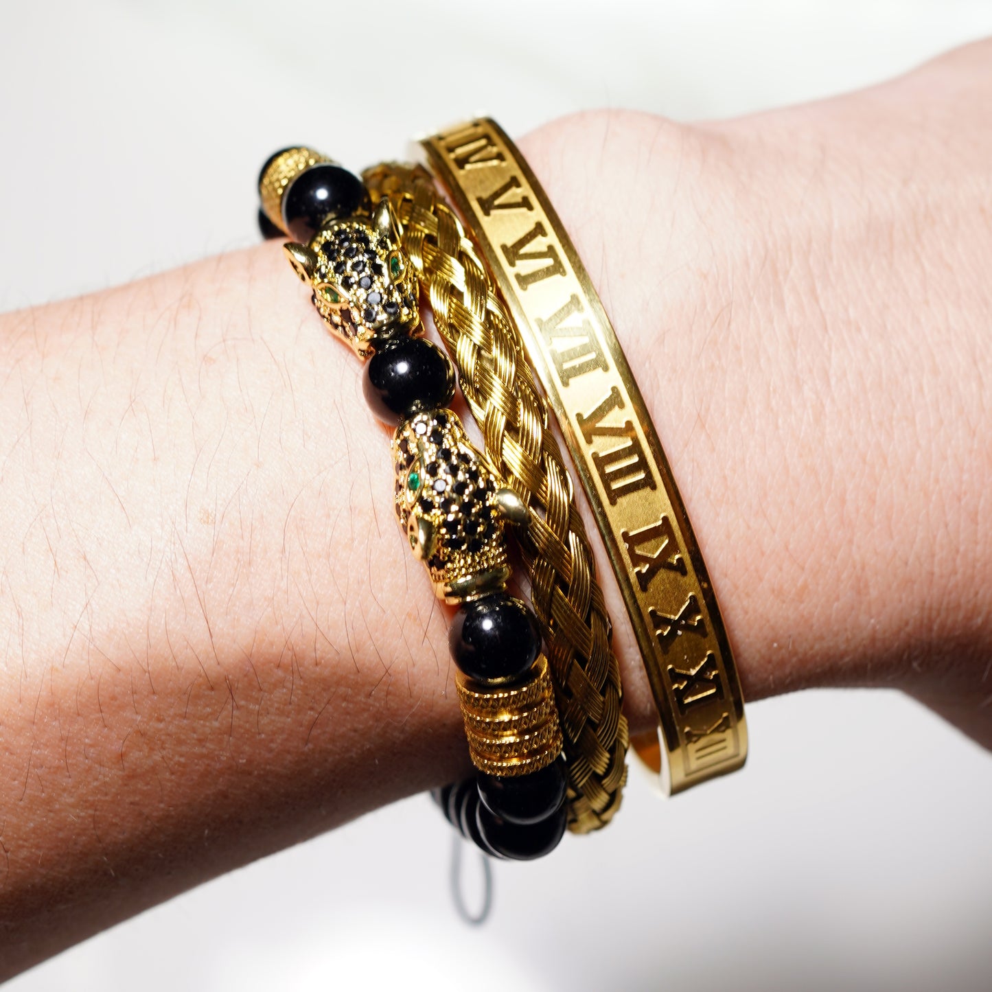 Adorn your wrist with the Five Elements Series TAOÉ Gothic Black Panther Braid + Golden Steel Numeral Bracelet Set, featuring gold-toned Roman numerals, braided details, and bold black panther accents for a powerful statement.