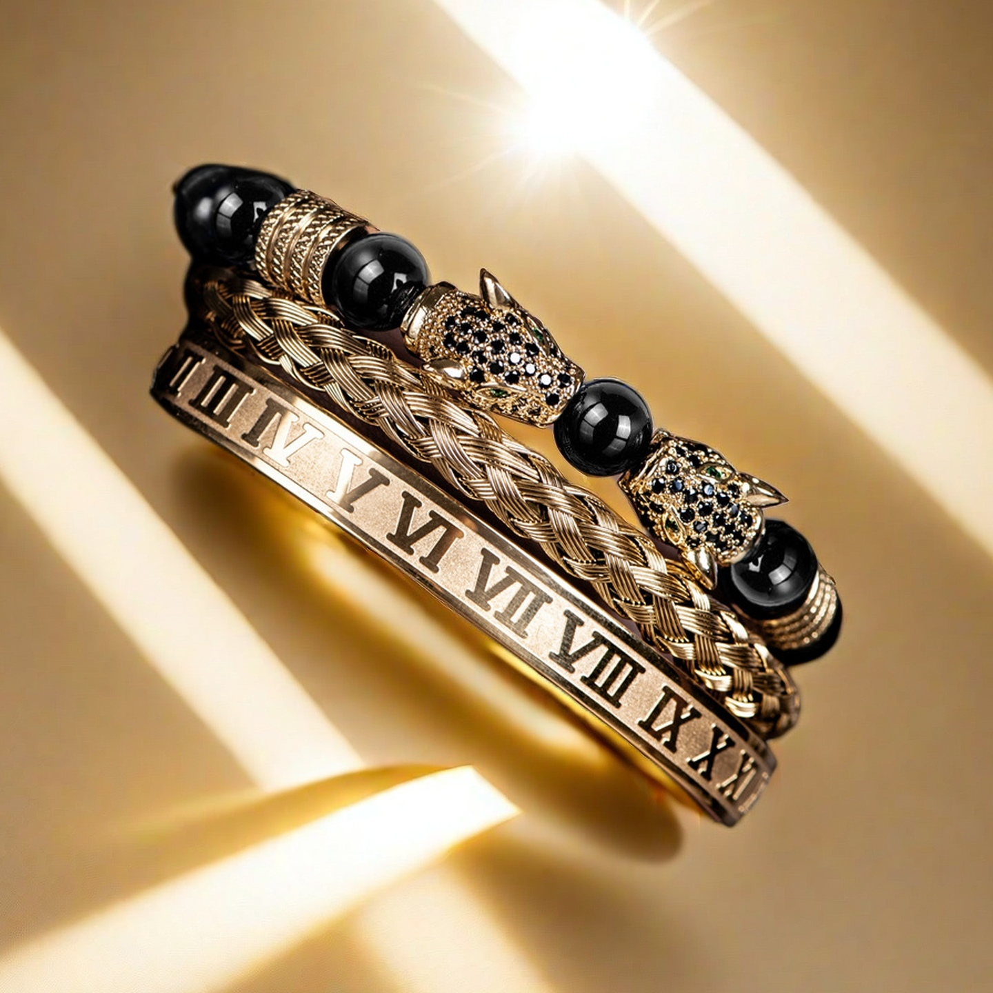 The Five Elements Series TAOÉ Gothic Black Panther Braid + Golden Steel Numeral Bracelet Panther Set-Metal features three stacked gold bracelets: a Roman numeral, a braided pattern, and one with black beads and fierce panther-shaped ends.