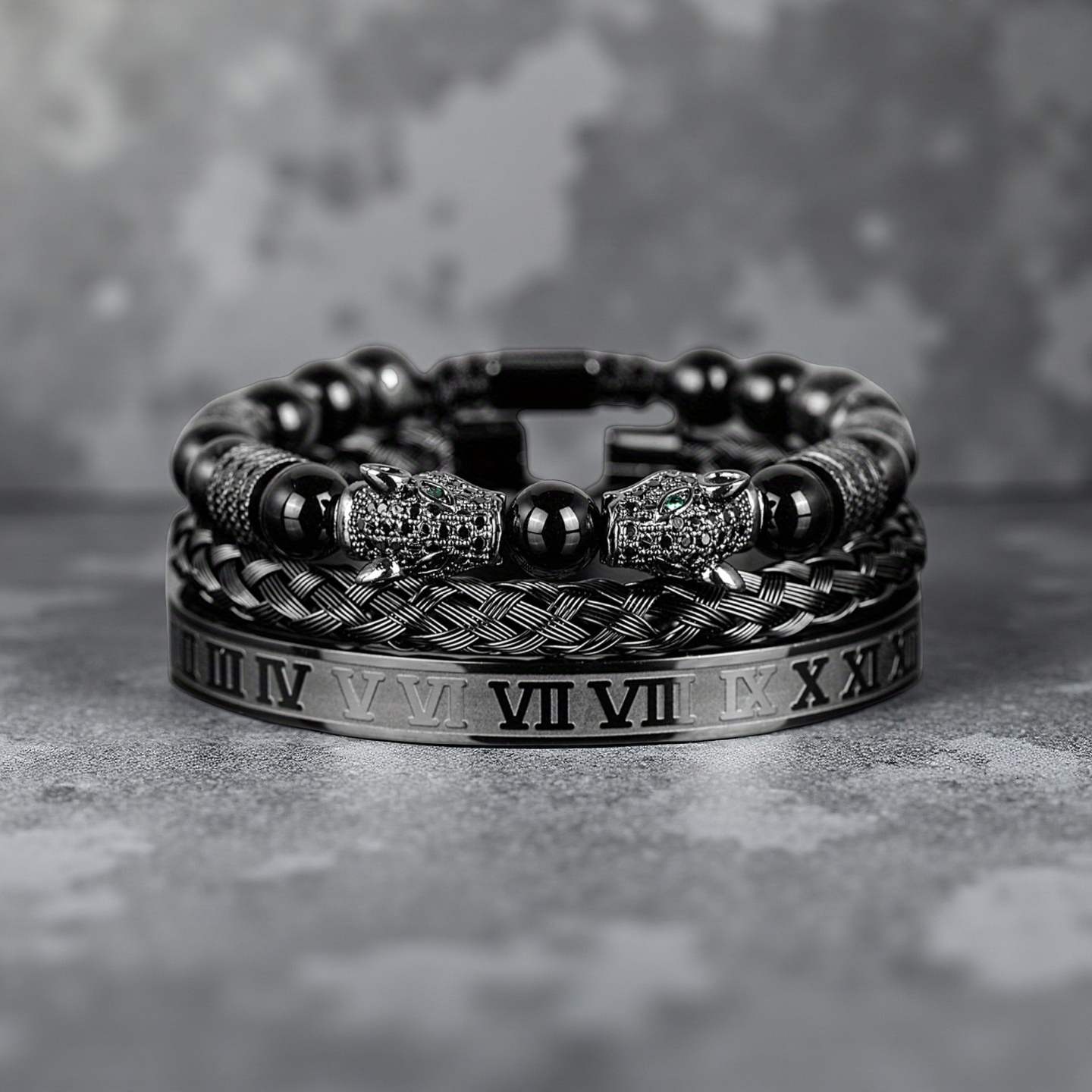 The Five Elements Series TAOÉ Gothic Black Panther Braid and Silver Steel Numeral Bracelet Set-Metal features stylish black and silver designs with animal head clasps, elegantly displayed on a textured gray surface.